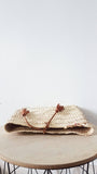 Moroccan straw clutch with leather